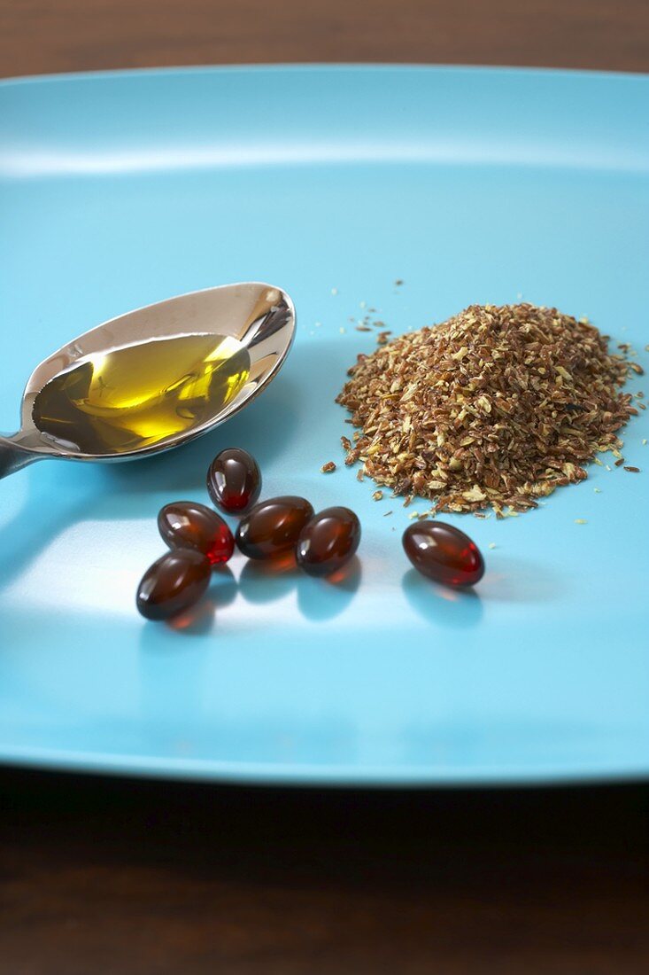 Flax Seeds, Flax Seed Oil and Flax Seed Capsules on a Plate