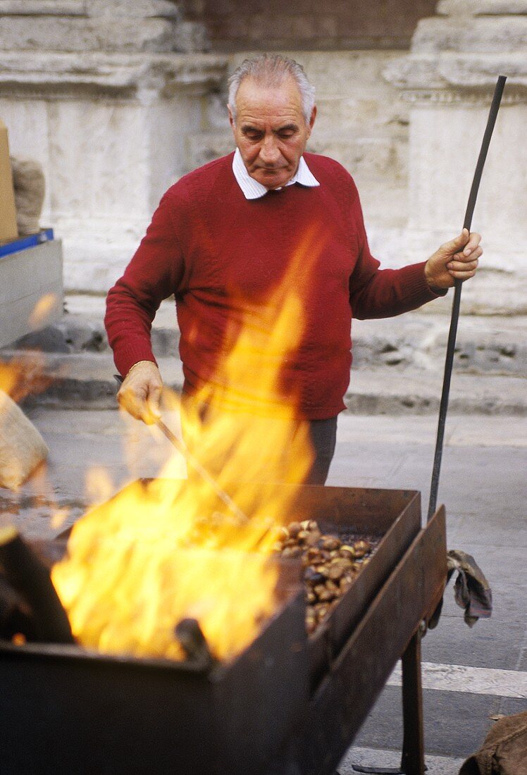 Male Street Vender Roasting Chestnuts in Rome, Italy, Flames