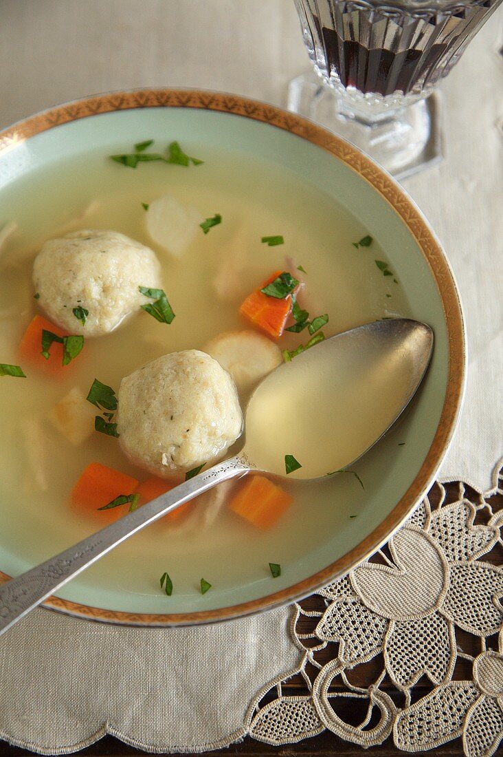 Bowl of Matzoh Ball Soup with Spoon, Wine