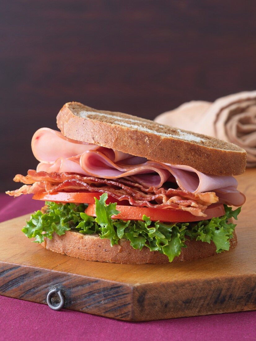 BLT with Ham on Marble Bread on Cutting Board