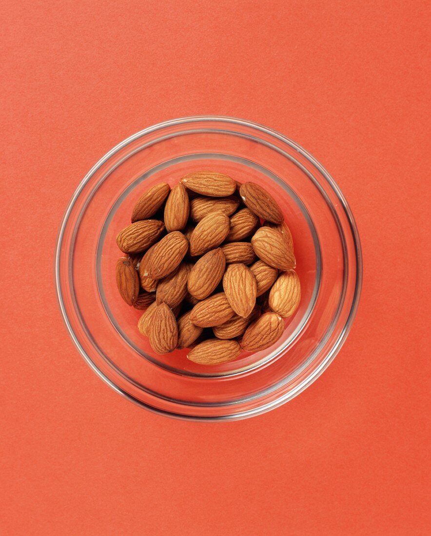 Almonds in a Glass Bowl, From Above, Orange Background