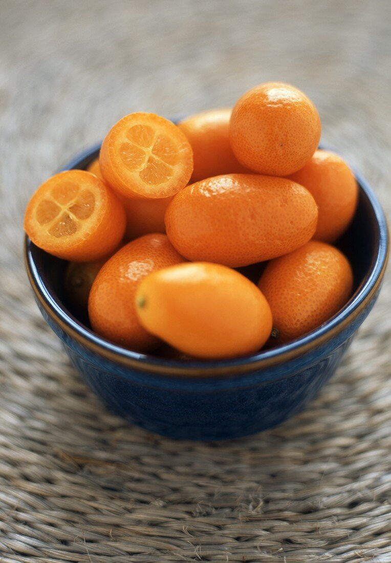Bowl of Fresh Whole Kumquats, One Halved