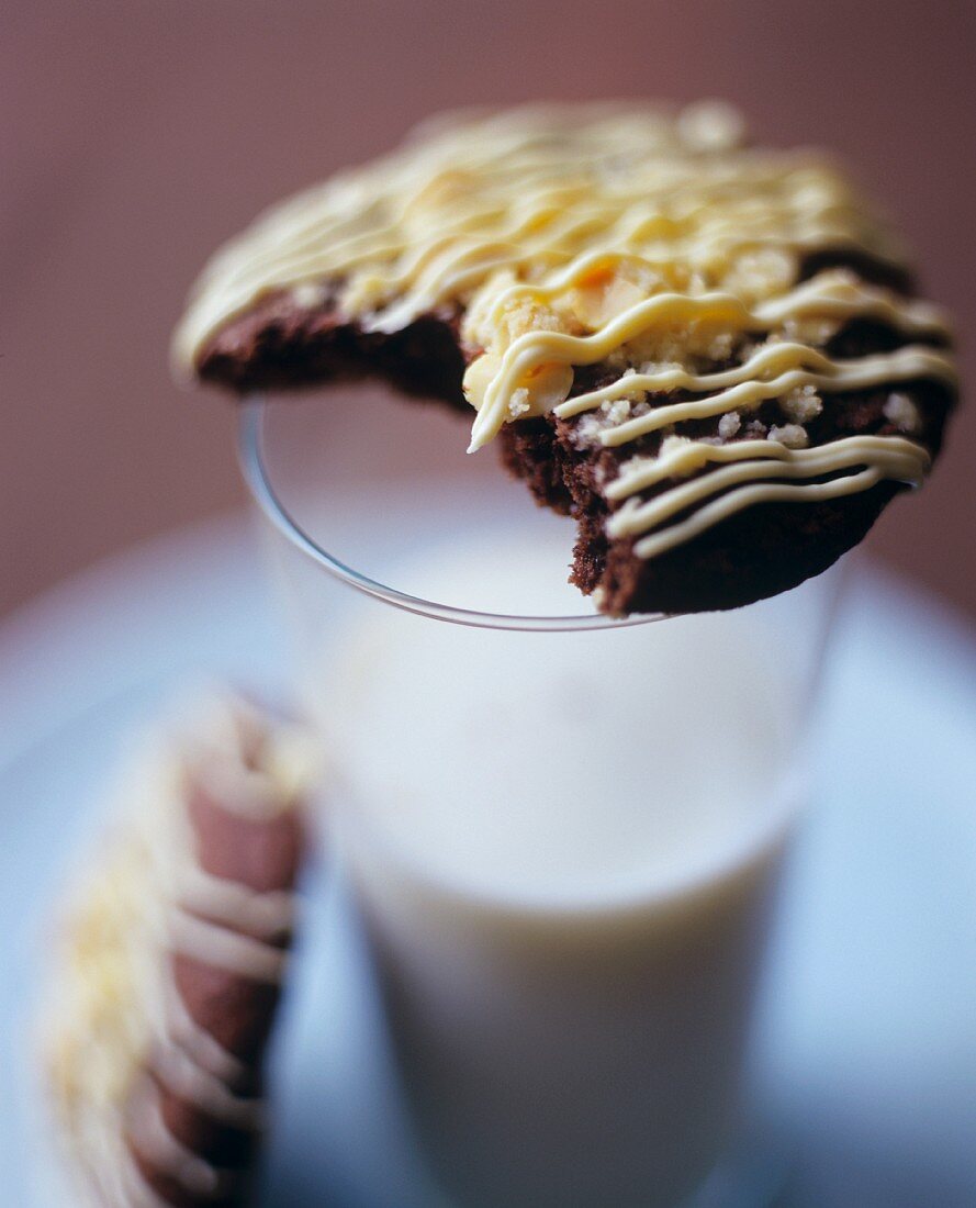 Chocolate biscuit on glass of milk