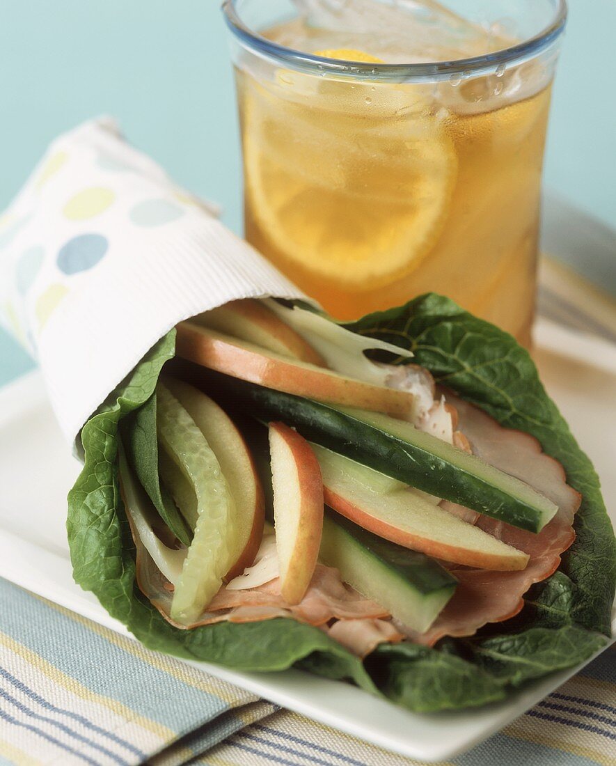 A Spinach Leaf Wrap with Ham, Cheese and Apples