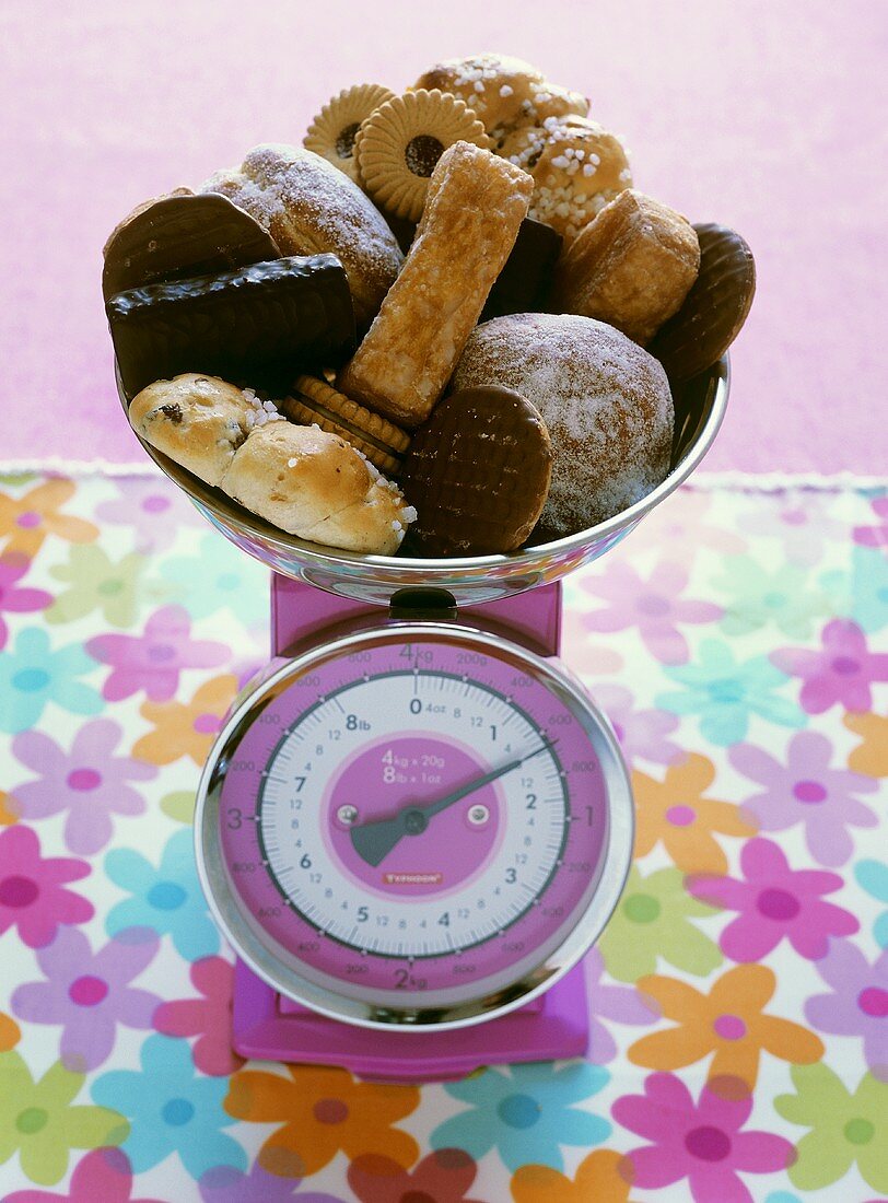 Assorted sweet pastries on scales