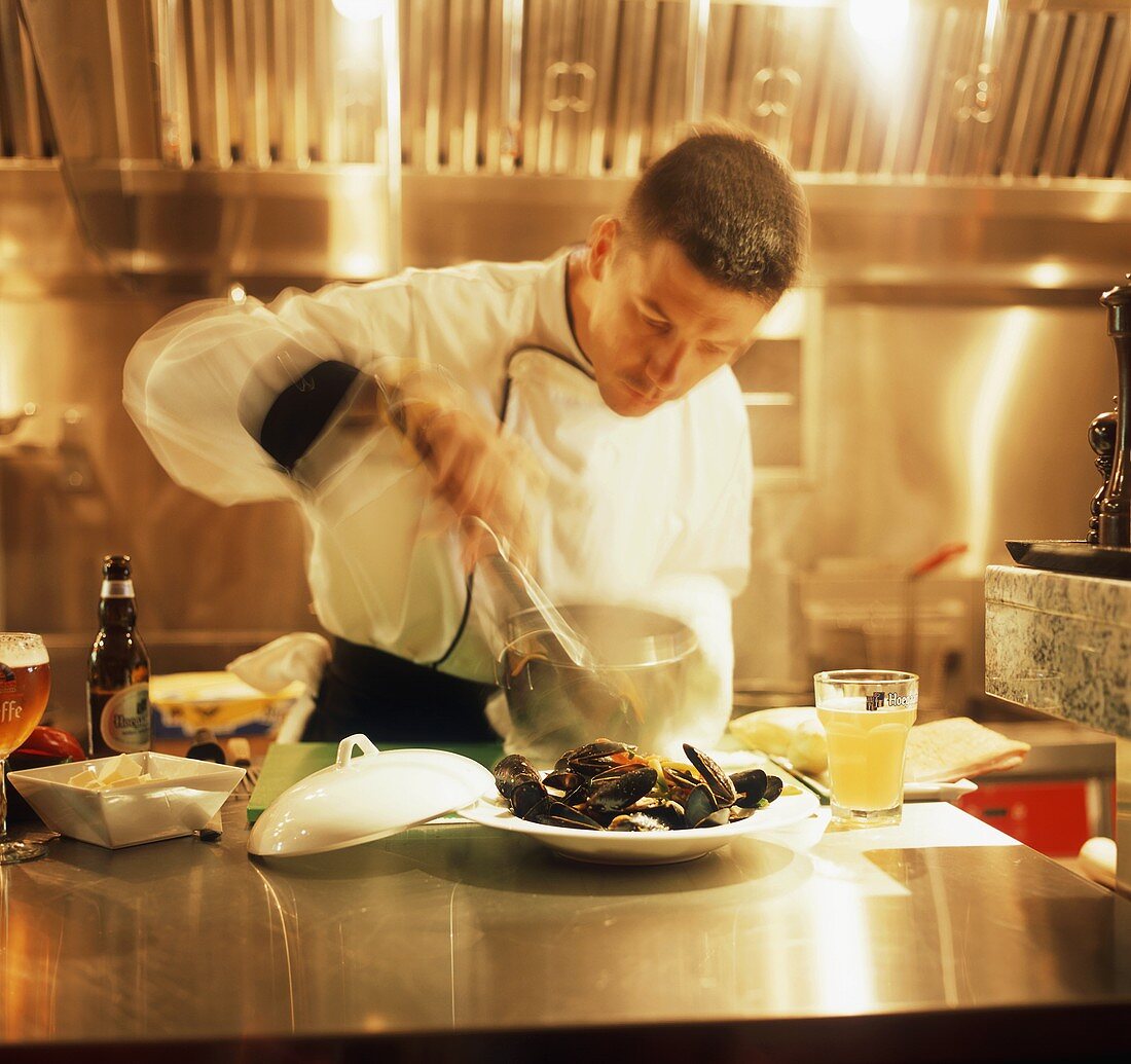 A Chef Preparing Mussels in a Restaurant Kitchen