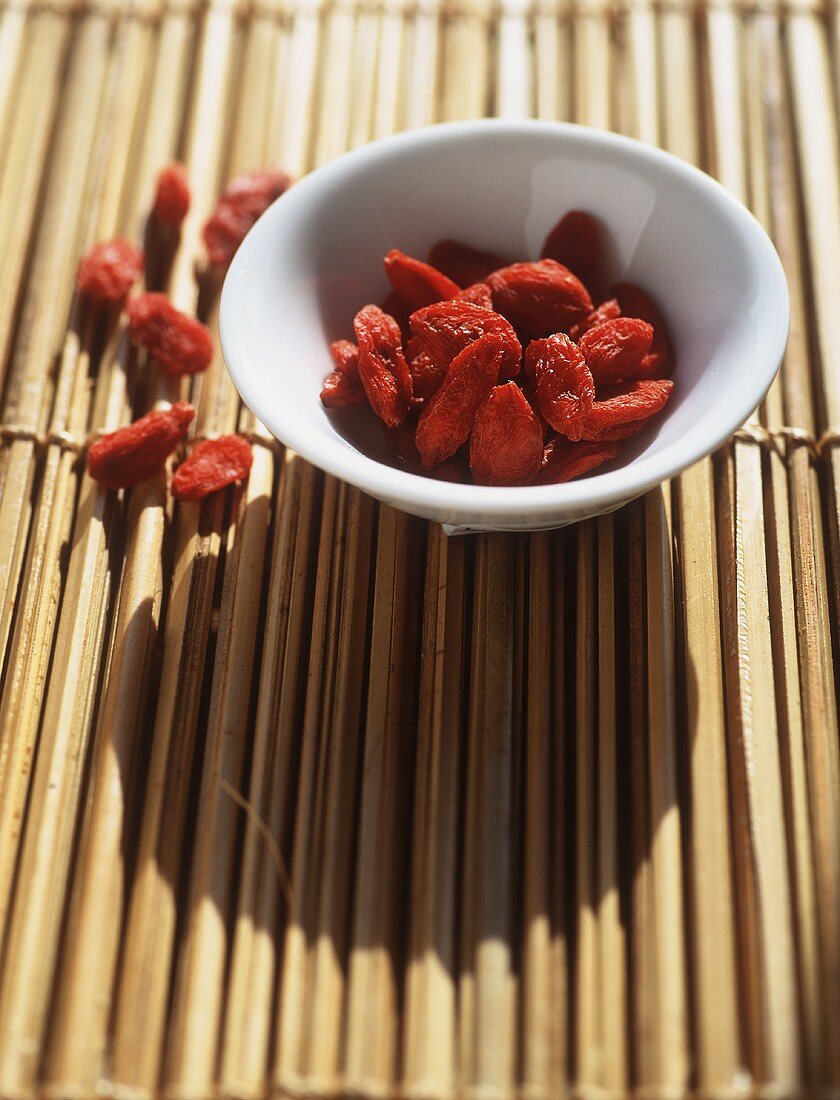 Dried berries in small bamboo bowl on bamboo