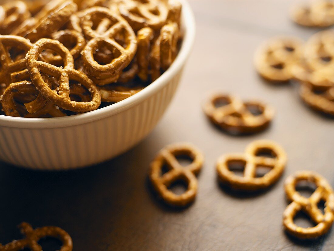 Salted pretzels in and beside bowl