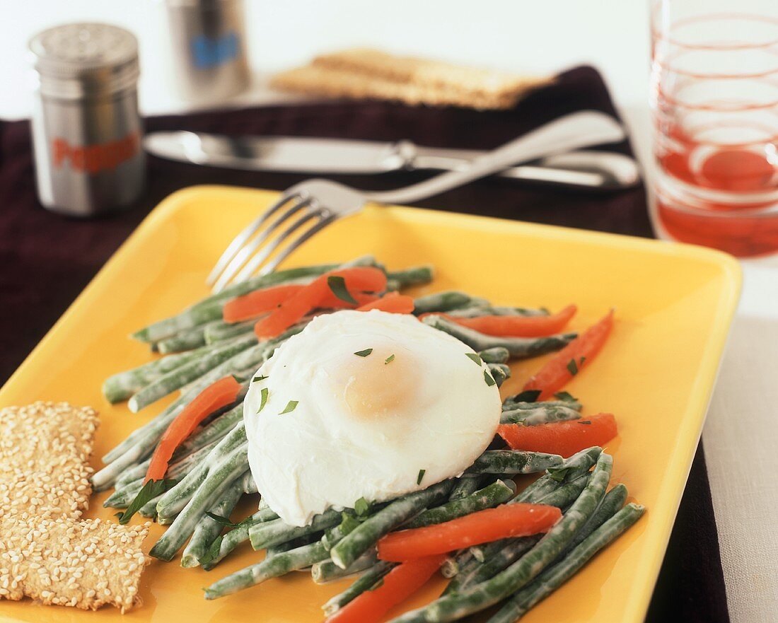 A Poached Egg on Green Bean and Red Bell Pepper Salad
