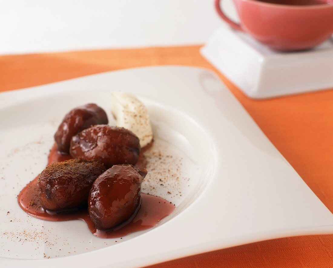 Wine Poached Dates with Crème Fraiche on a White Plate