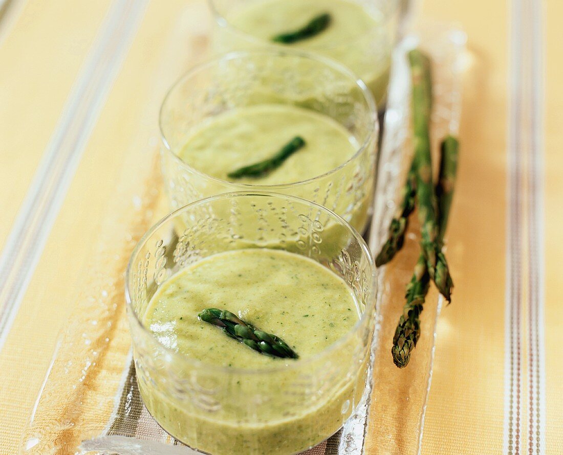 Green asparagus soup in glasses