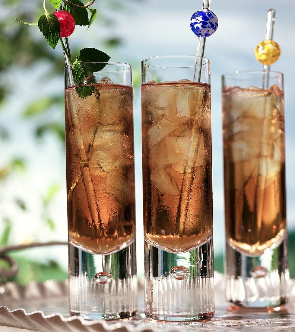Three glasses of iced tea on silver tray