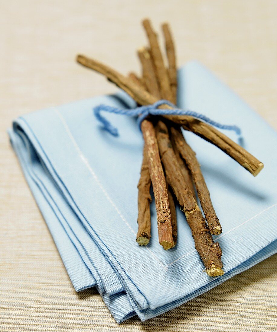 Licorice Sticks Tied with Blue String on a Blue Napkin