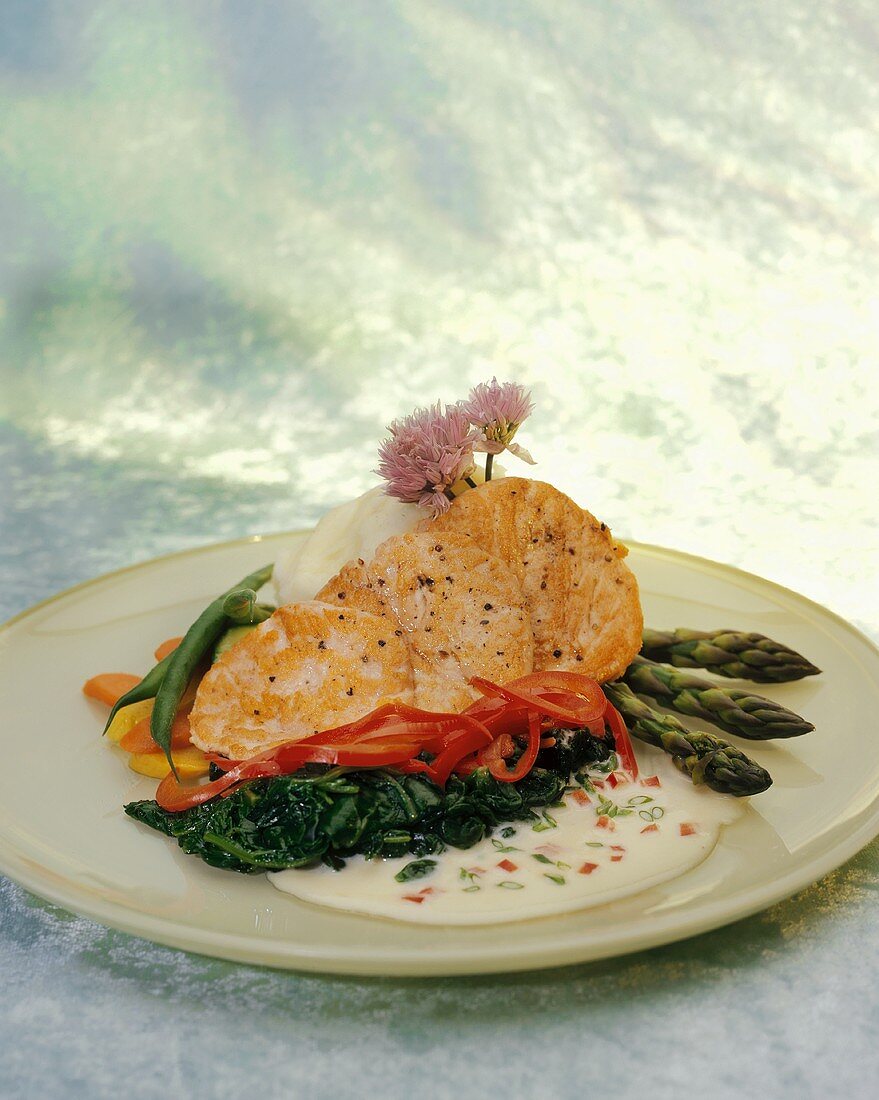 Salmon fillet with cream sauce and steamed vegetables
