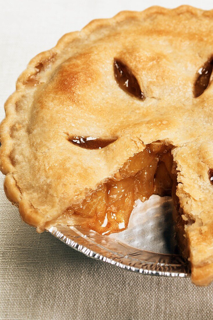 An Apple Pie with Slice Removed in a Foil Pan