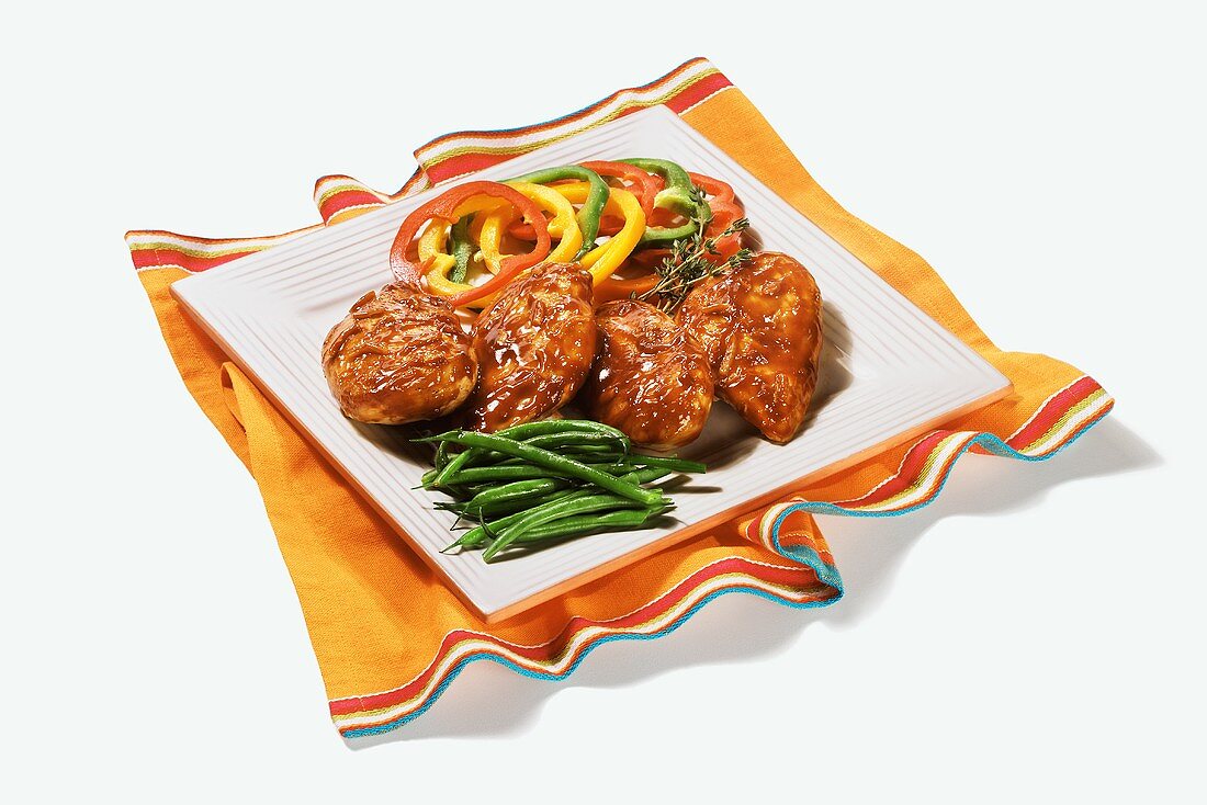 Barbecued Chicken on a Square Platter with Green Beans and Bell Peppers