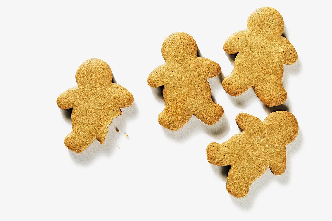Four Gingerbread People; One with Bite Taken Out