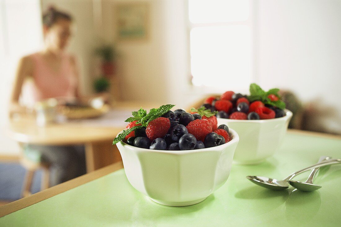 Fresh Raspberries and Blueberries in a Bowl with Mint