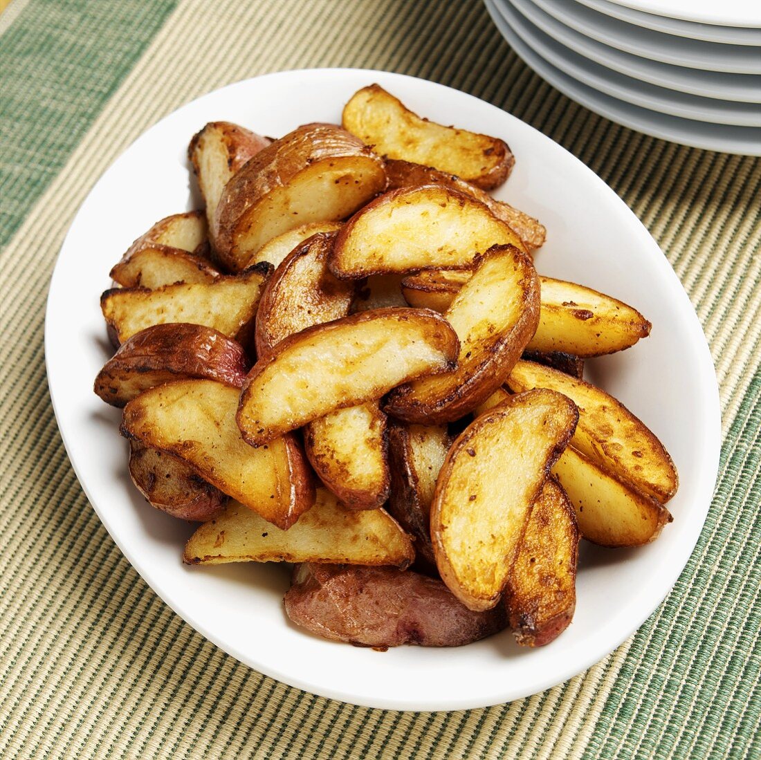 Fried red potatoes on white plate