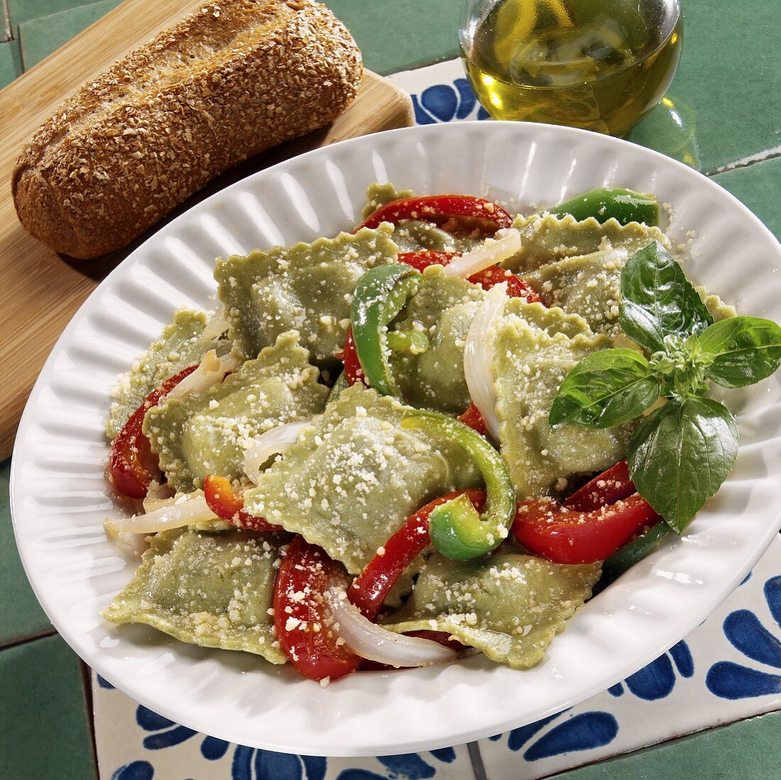 Spinach ravioli with peppers, onions and cheese