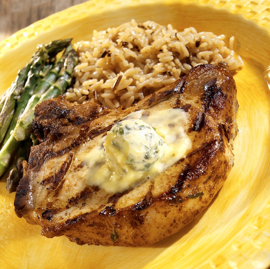 Barbecued pork chop with basil and garlic butter