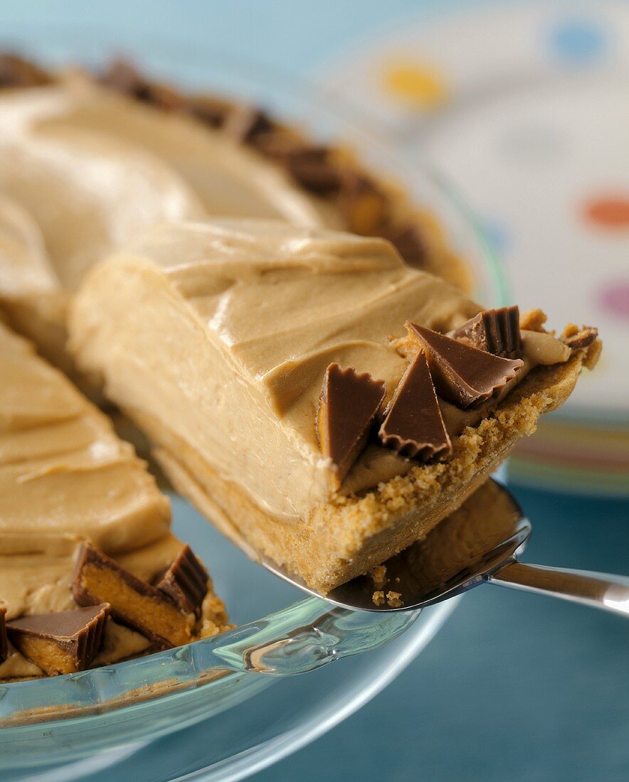A Spatula Lifting a Piece of Peanut Butter Pie from a Pie Dish