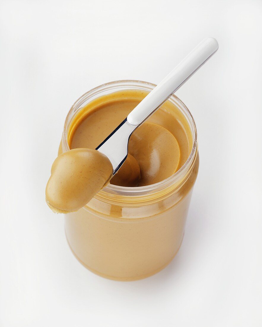 A Jar of Peanut Butter with Spreader