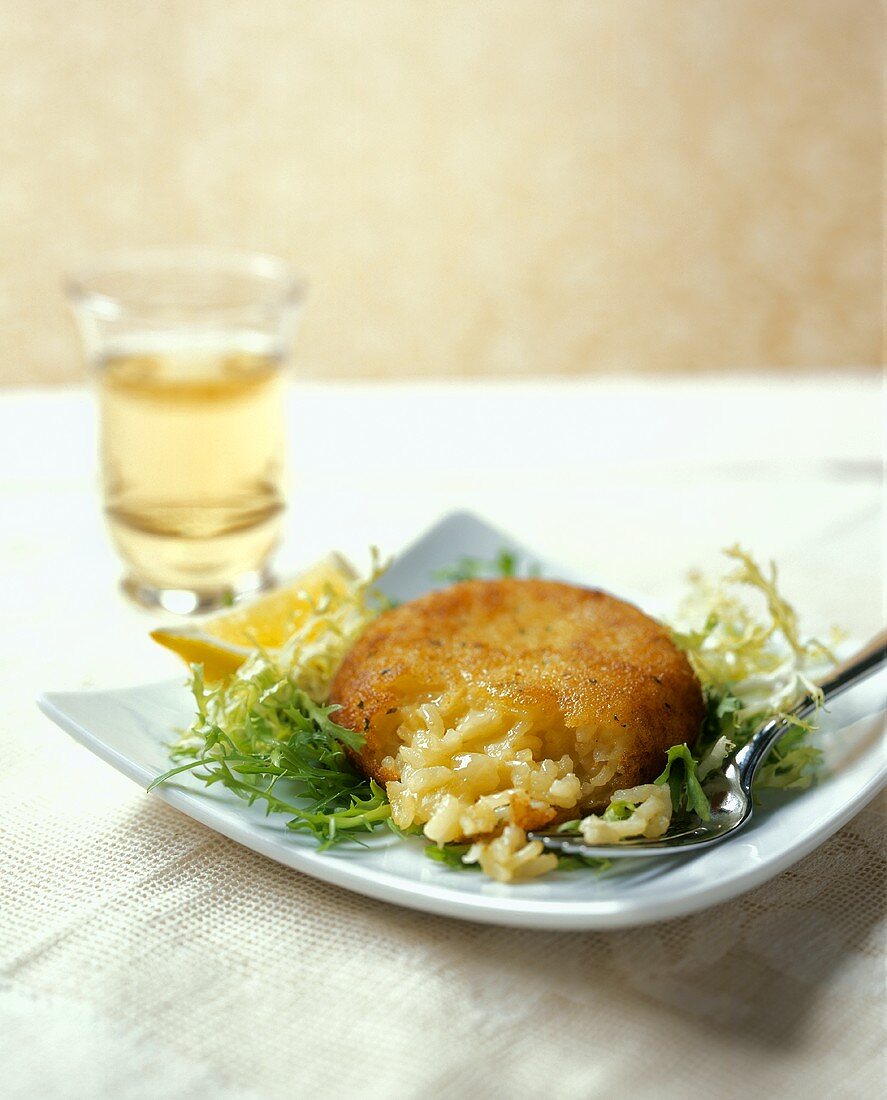 A Risotto Cake on a Bed of Frisee