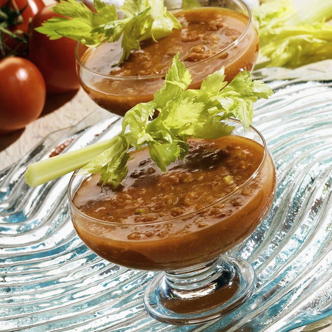 Gazpacho in a Glass Bowl with a Celery Stalk Garnish