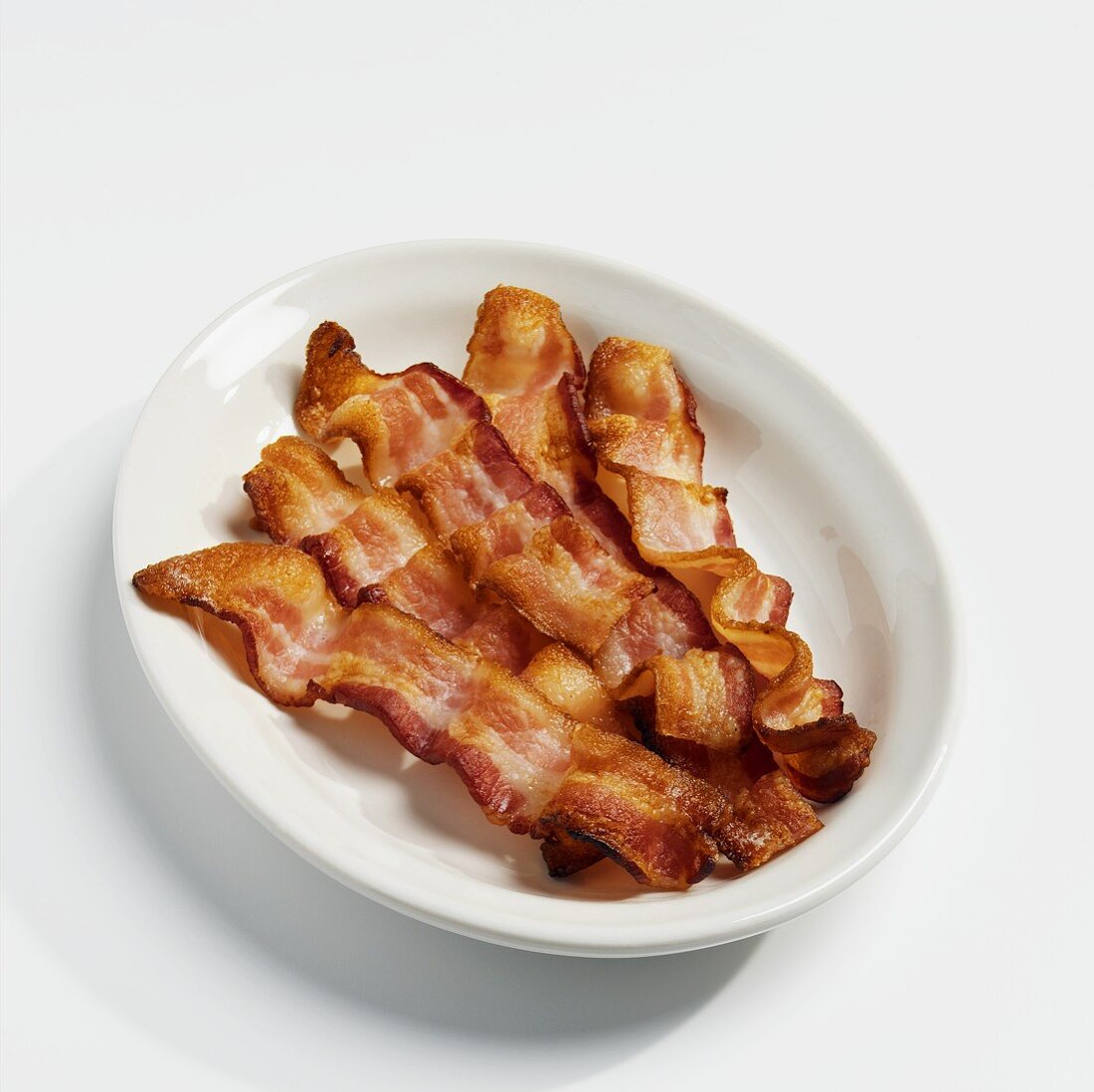 Five Strips of Bacon on a White Plate