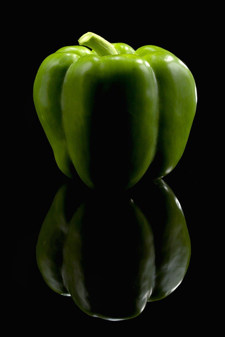 A Green Holland Pepper on Black with Reflection