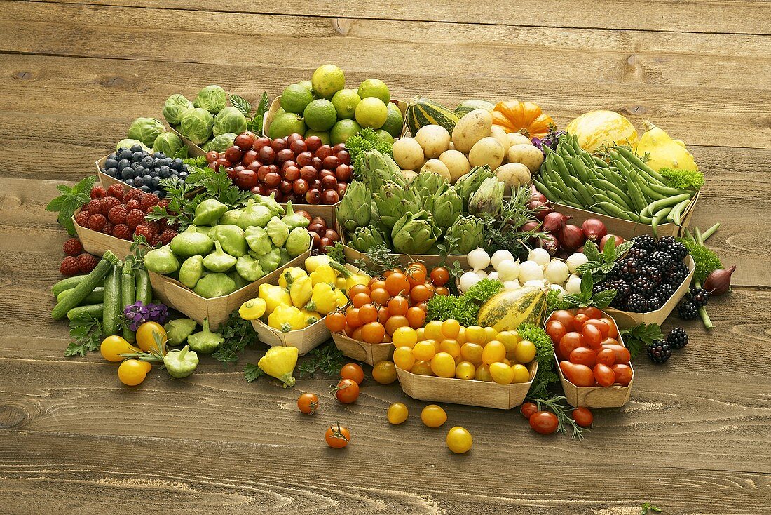 Assorted Fresh Fruits and Vegetables in Containers on Wooden Background