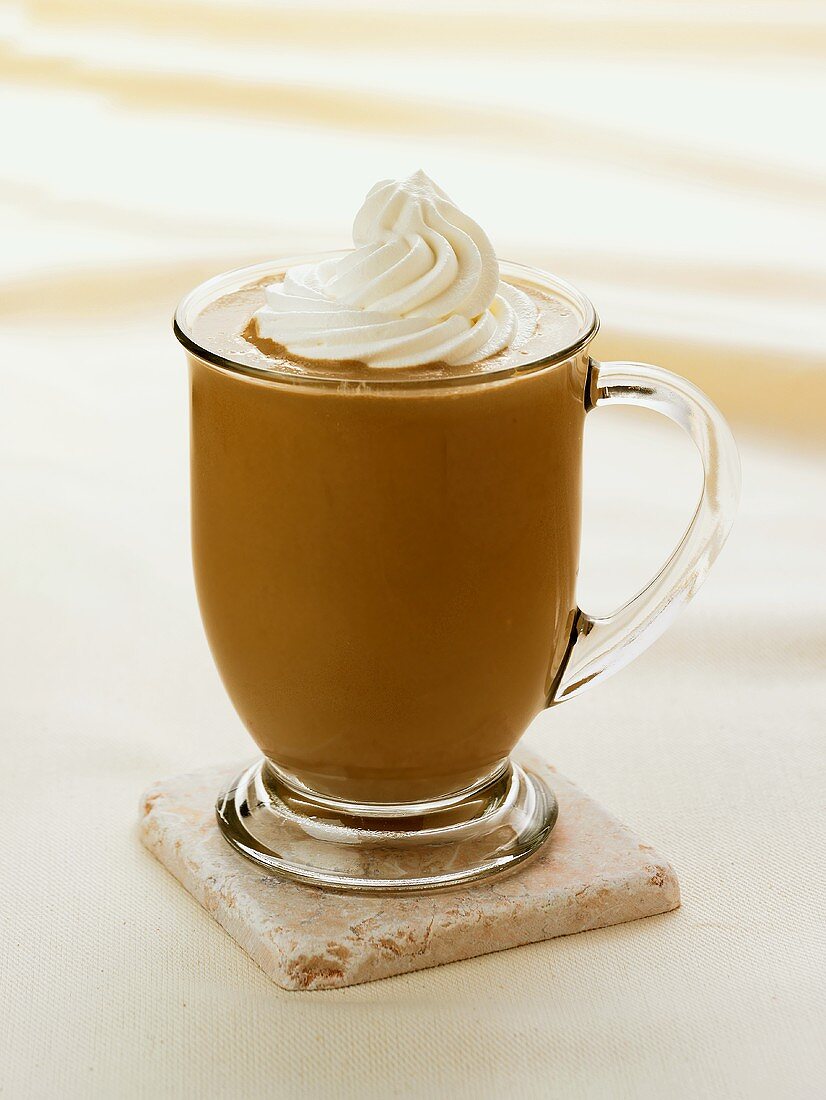 A Mocha Latte with Whipped Cream in a Glass Mug