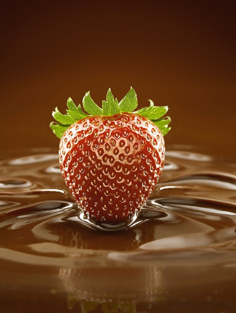 A Fresh Strawberry in a Pool of Chocolate