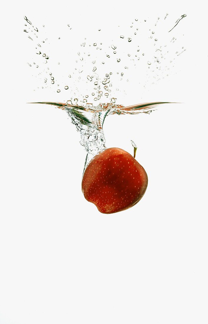 A Red Apple Splashing into Water