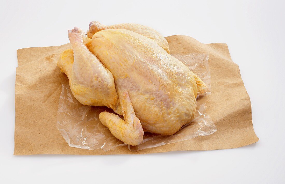 A Whole Uncooked Chicken on Butcher's Paper