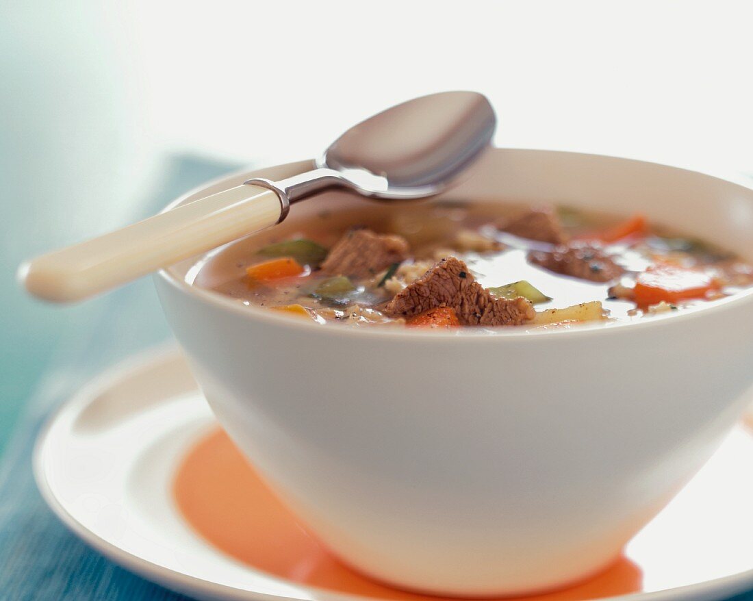 Beef and Barley Soup in a Bowl with a Spoon