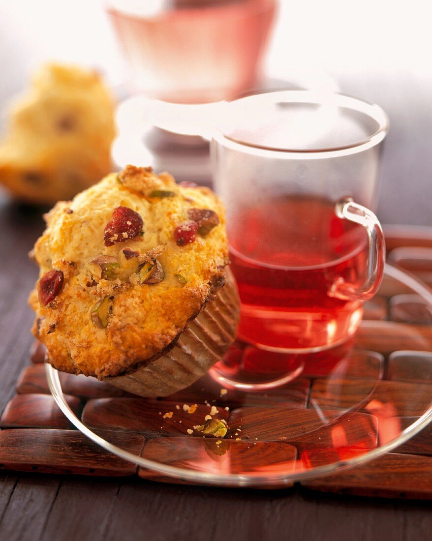 An Orange-Cranberry-Pistachio Muffin with Tea
