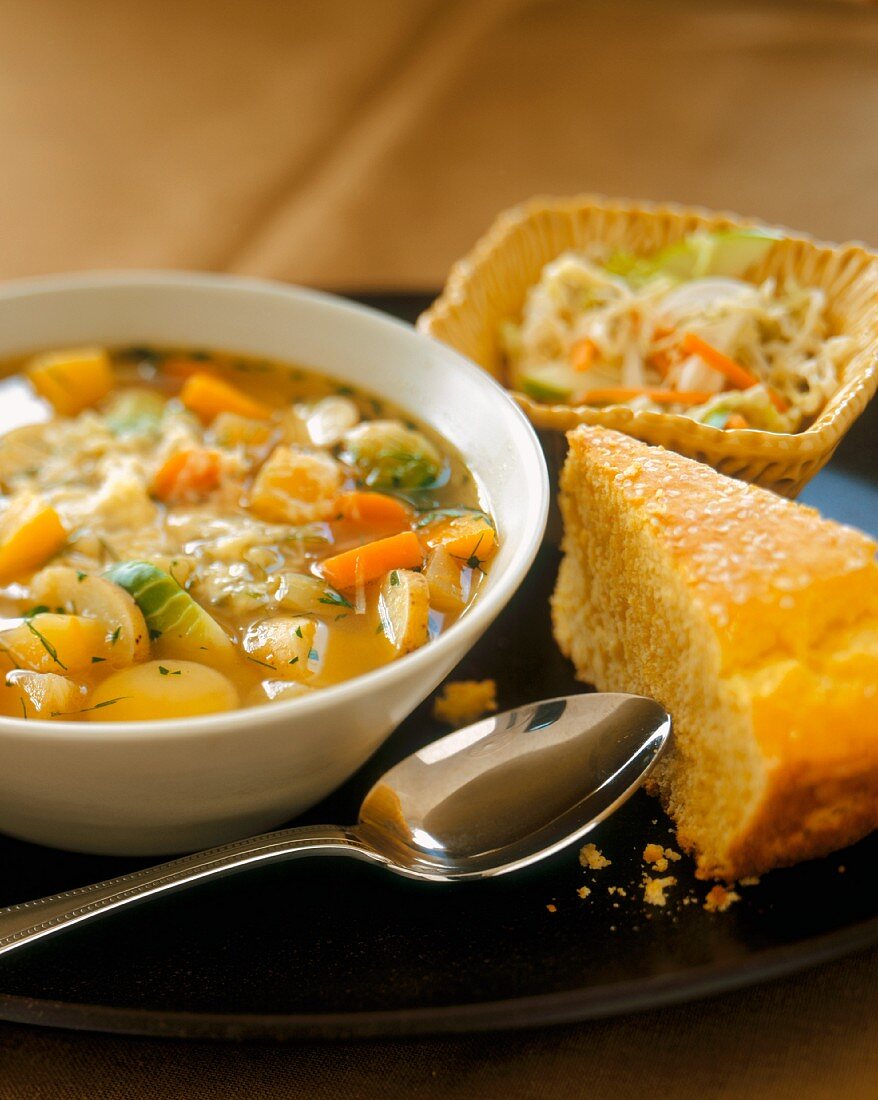 A Bowl of Hearty Root Vegetable Soup with Cornbread