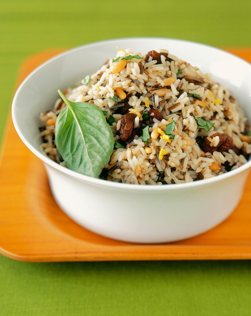 Rice Pilaf with Basil in a White Bowl on a Wooden Tray