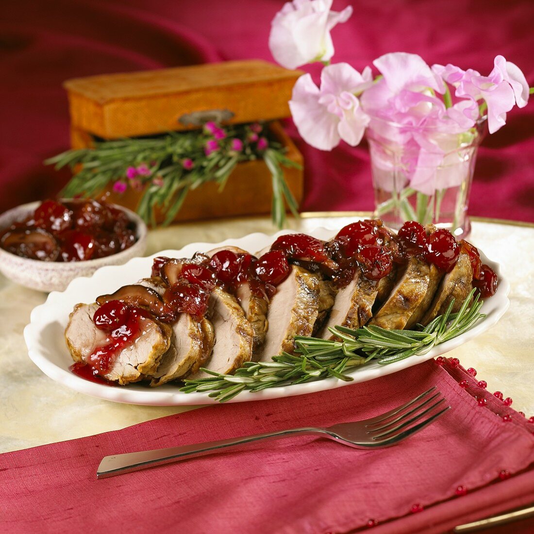 Mustard Marinated Sliced Pork Tenderloin with Cherry Compote on a Platter