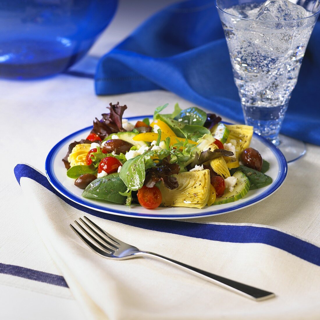 A Greek Salad with a Glass of Seltzer Water