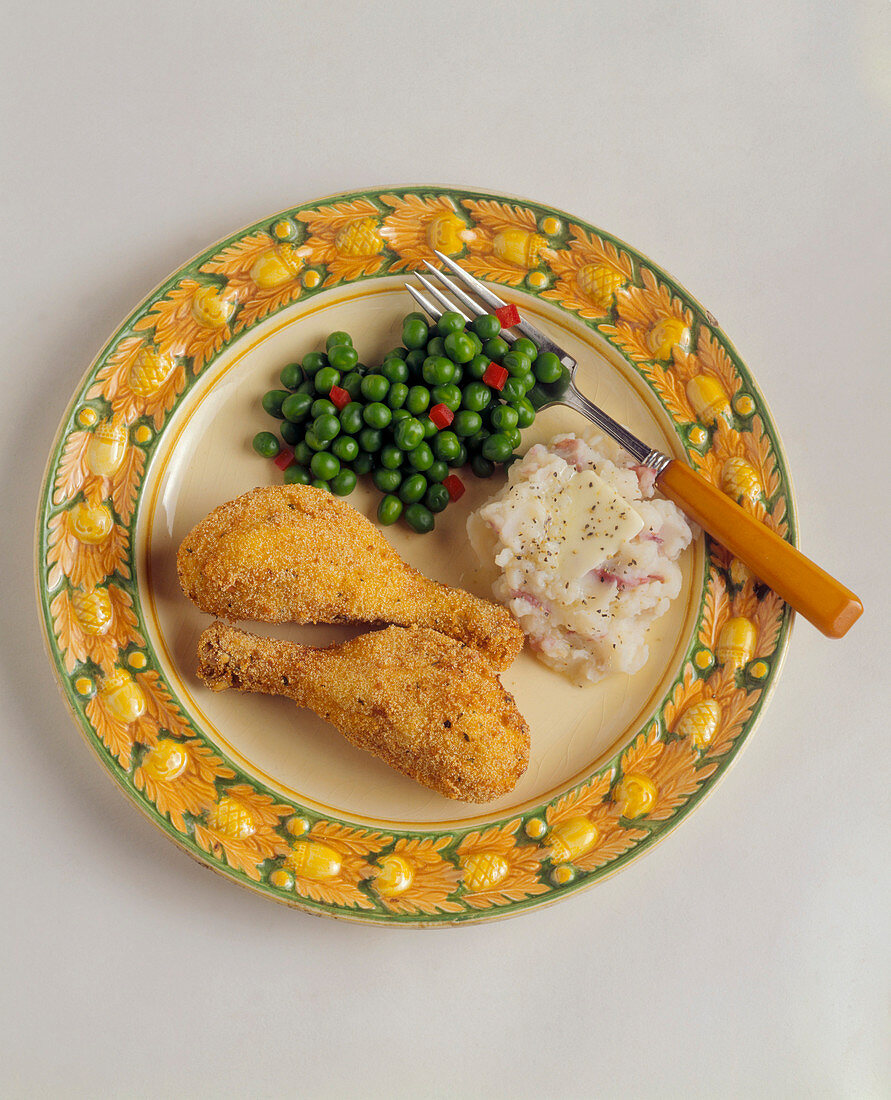 Fried Chicken Legs with Mashed Red Potatoes and Butter and Peas