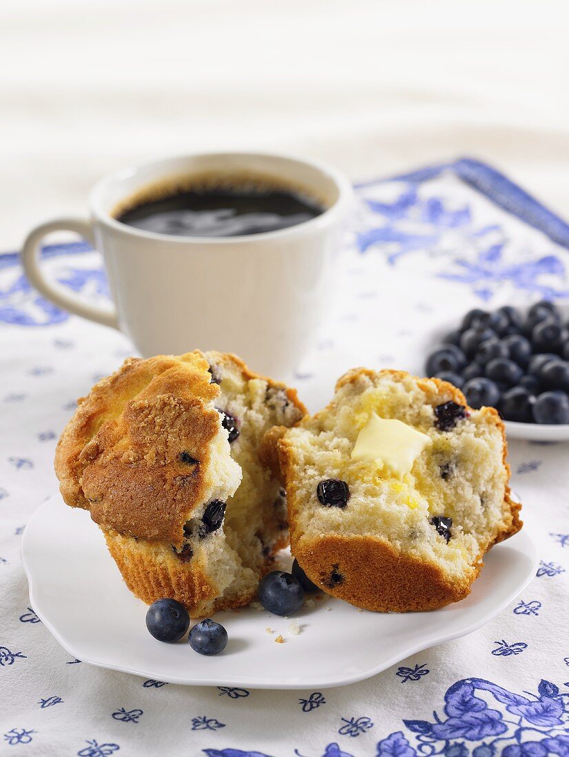 A Blueberry Muffin, Halved, with Butter and Coffee