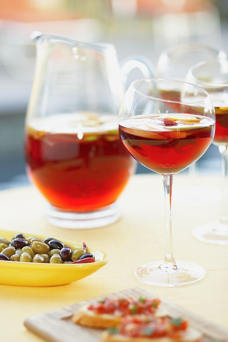 Sangria im Glas und Krug, Oliven und Bruschetta