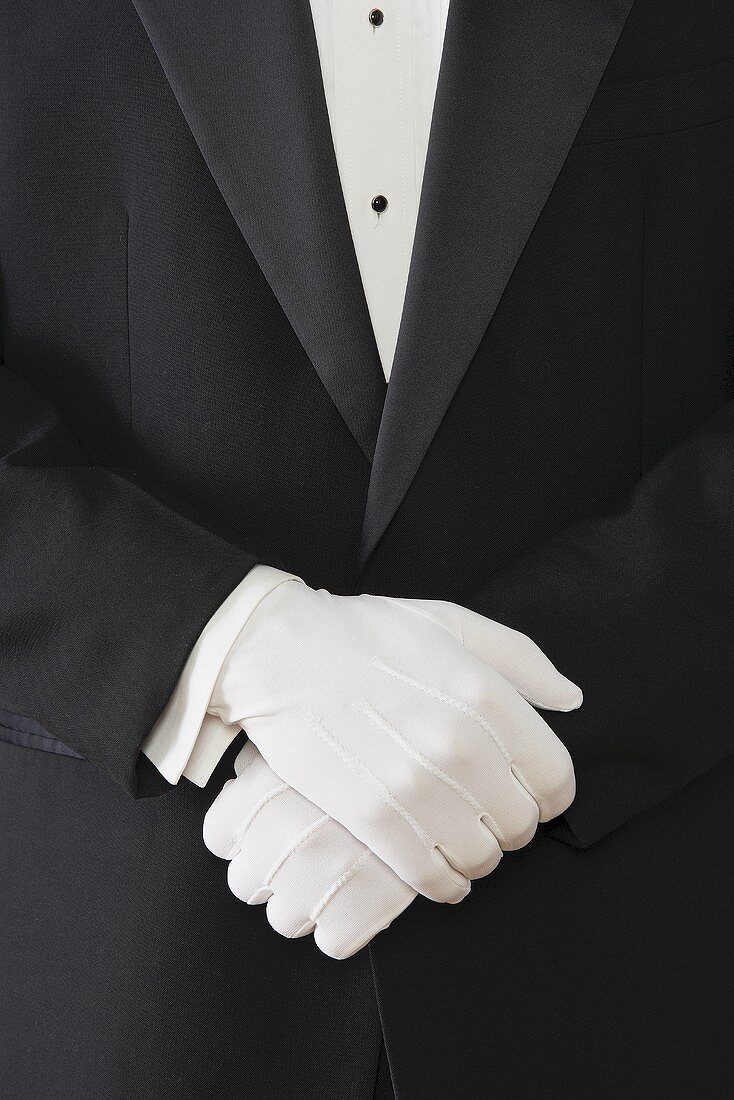 A Waiter with Crossed Gloved Hands