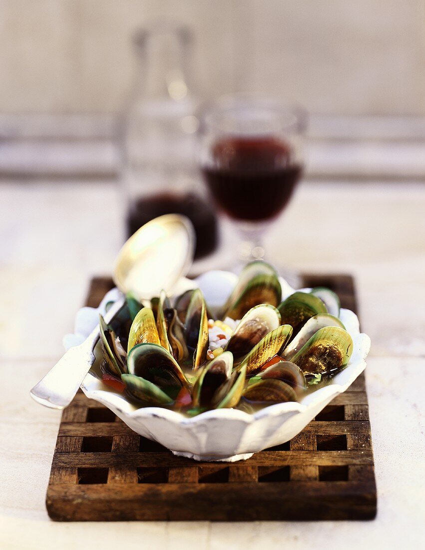 Green Mussels in White Bowl with Spoon and Red Wine