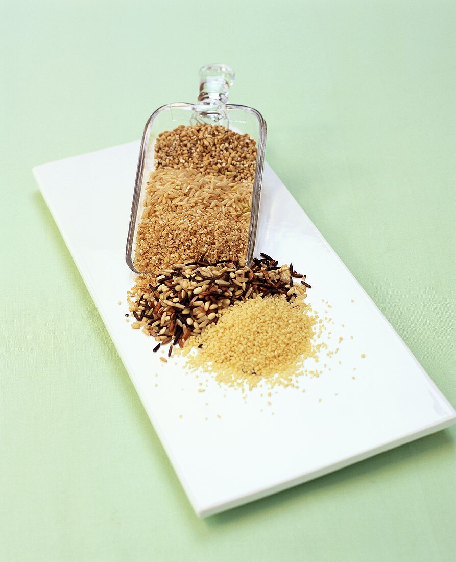 Assorted Uncooked Grains with a Glass Scoop