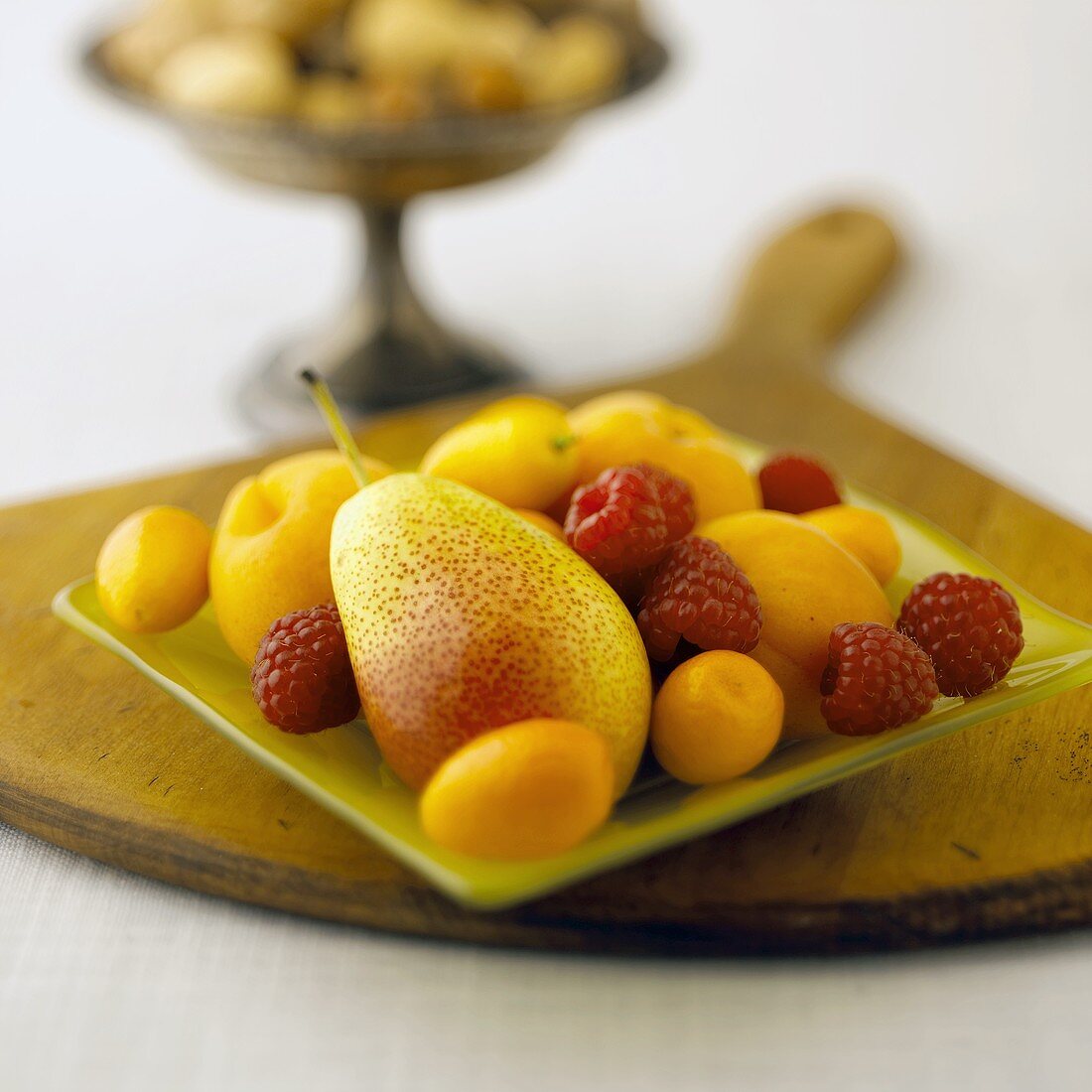 Apricots, Raspberries and a Pear on a Square Glass Plate