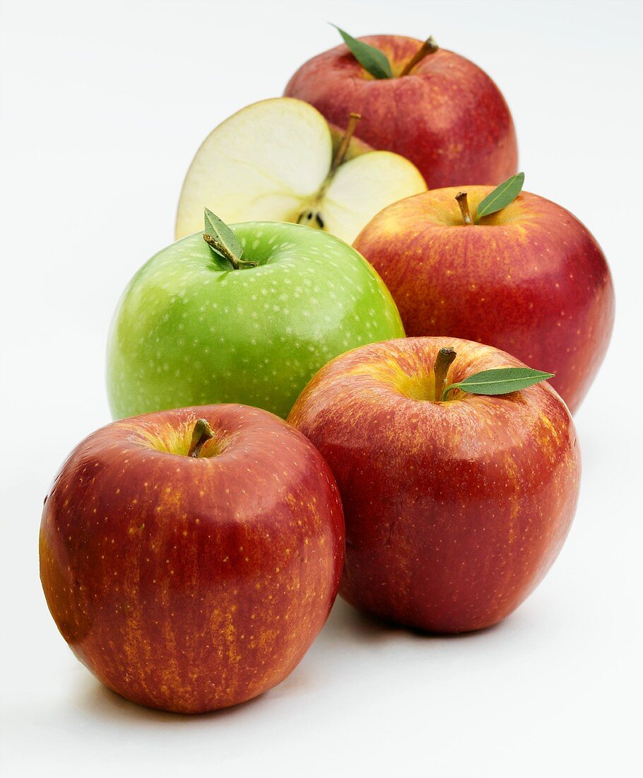A Group of Red Apples with One Green Apple